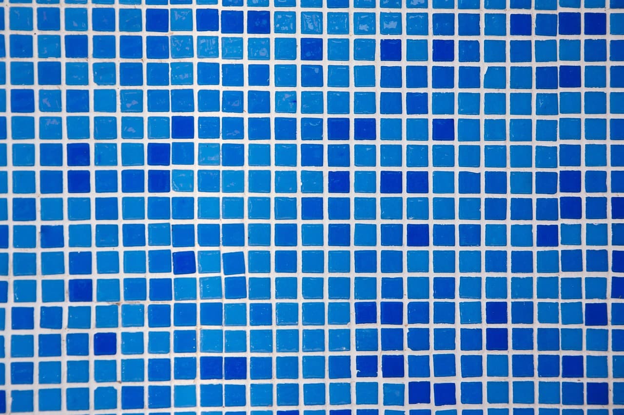 Deep blue glass mosaic tiles in close detail